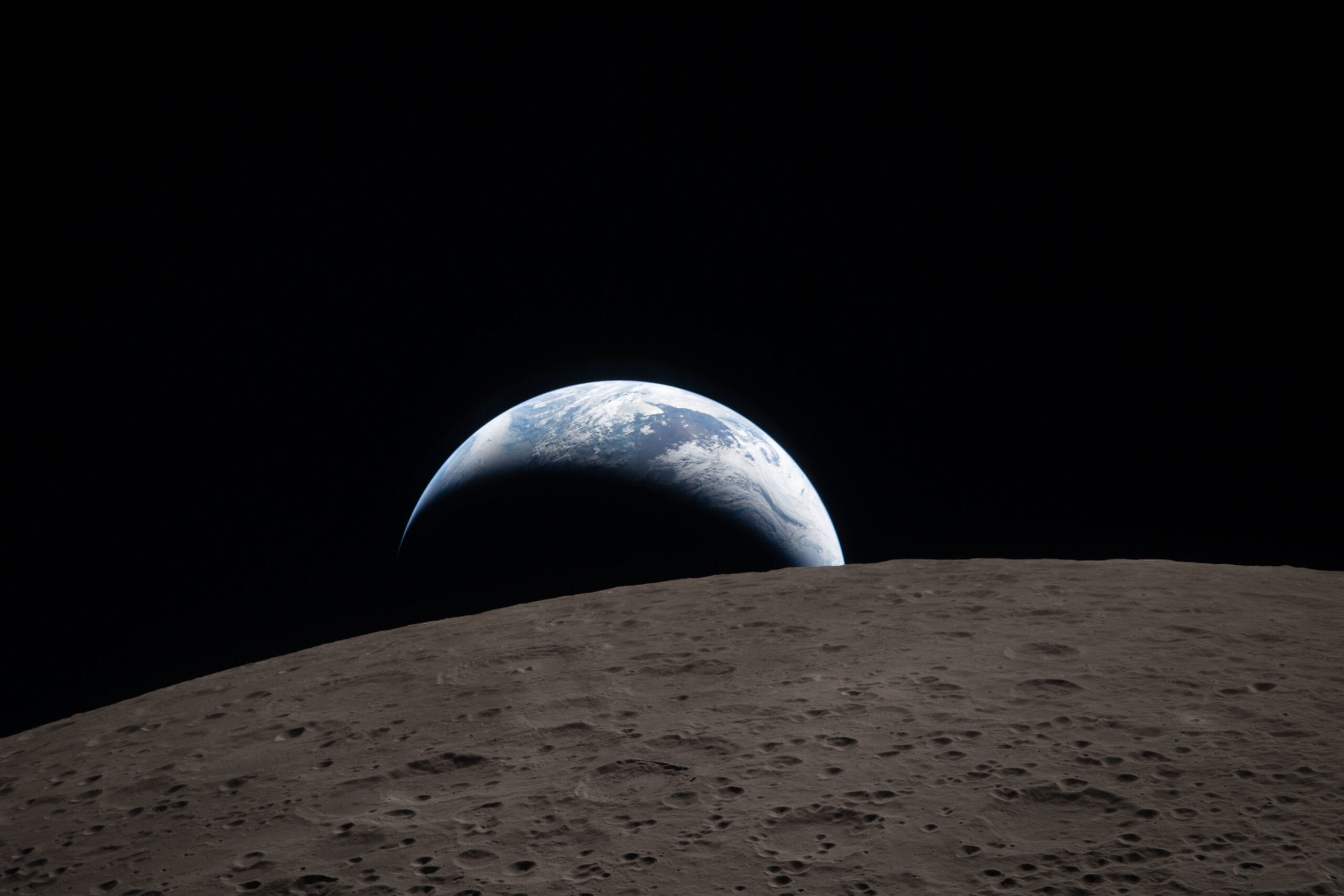 A photo taken during the Artemis II mission around the Moon, showing the Earth setting beyond