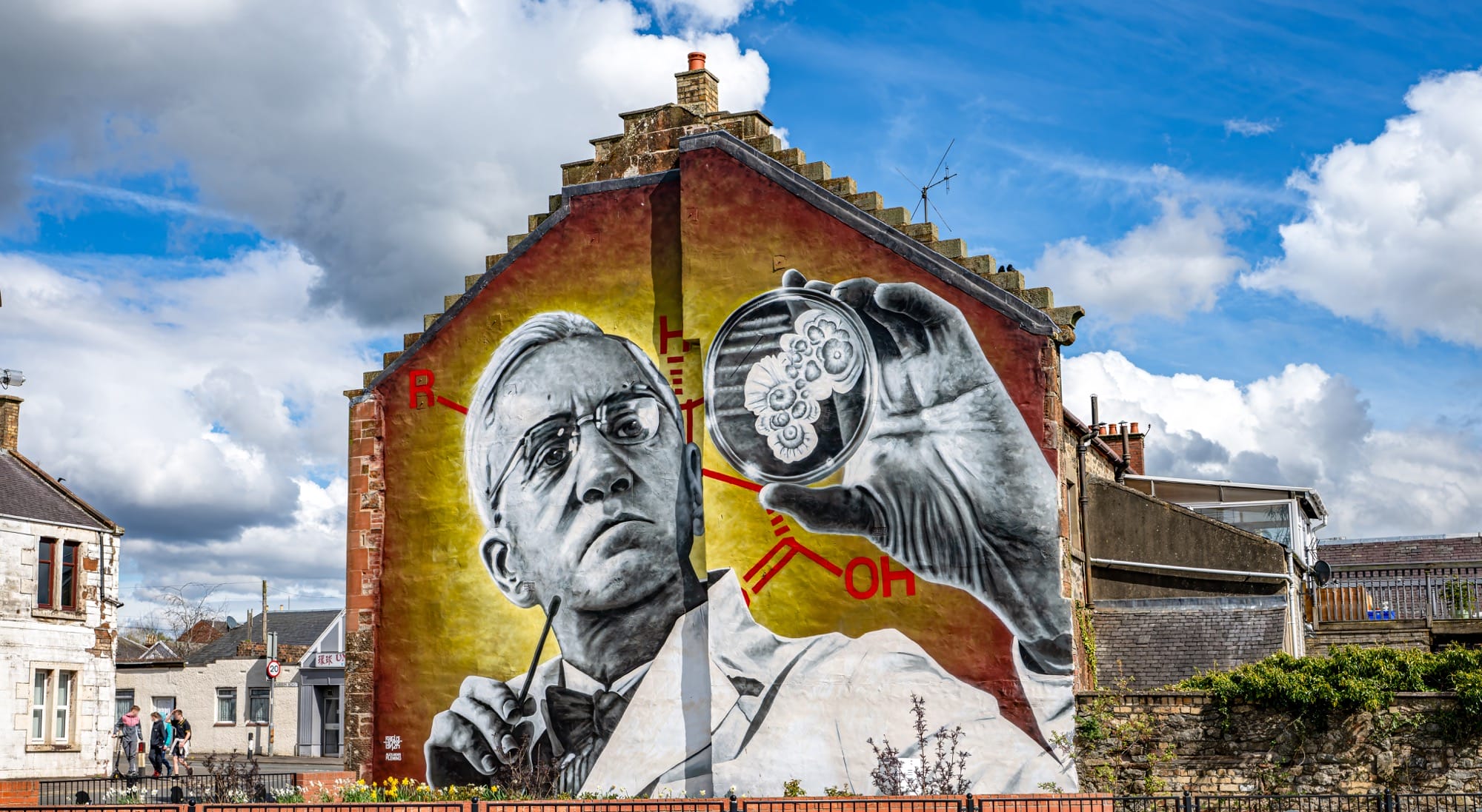 a mural by Rogue-one of Alexander Fleming inspecting a biological specimen