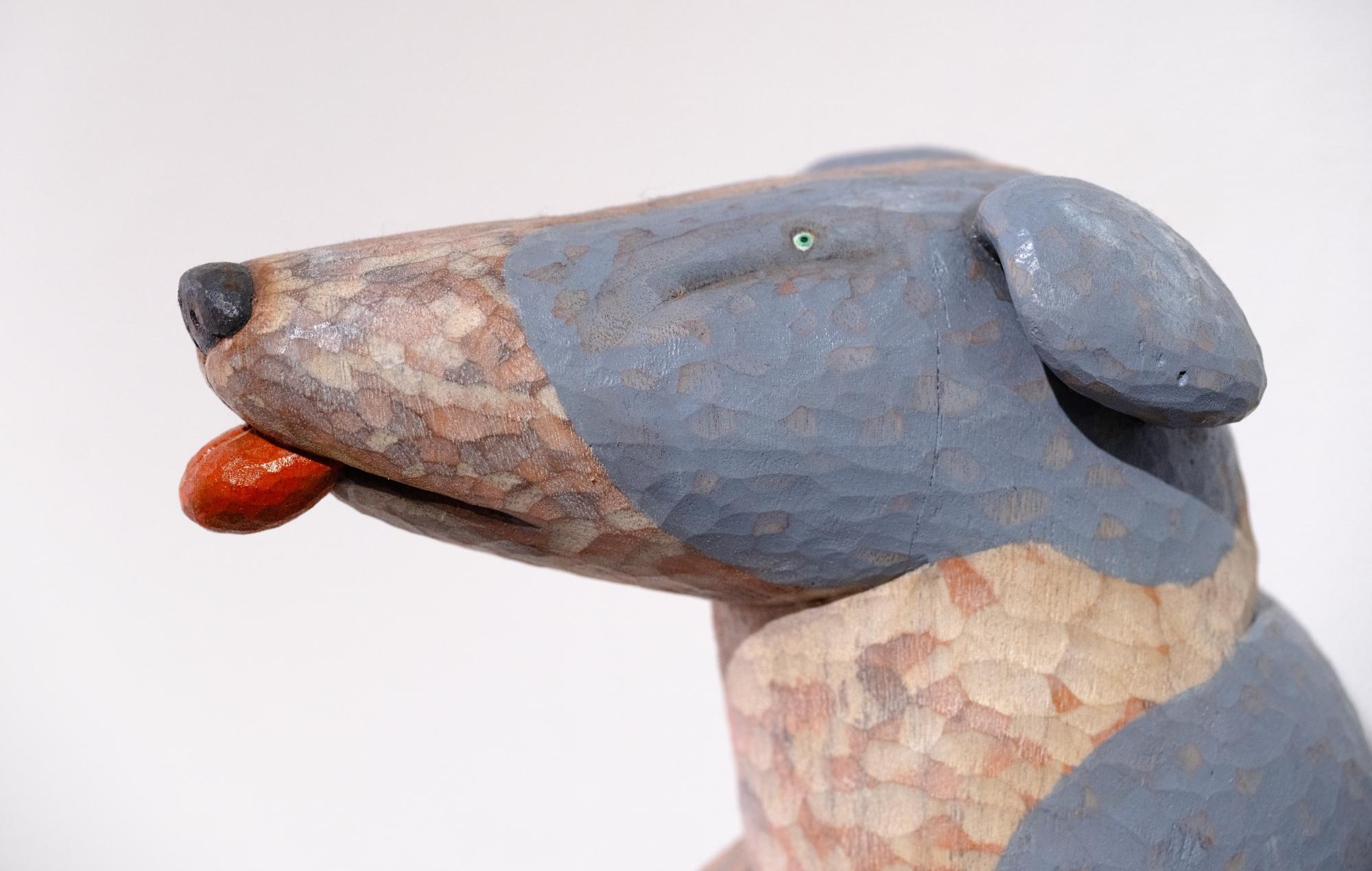 profile detail of a wood-carved whippet sculpture by Misato Sano